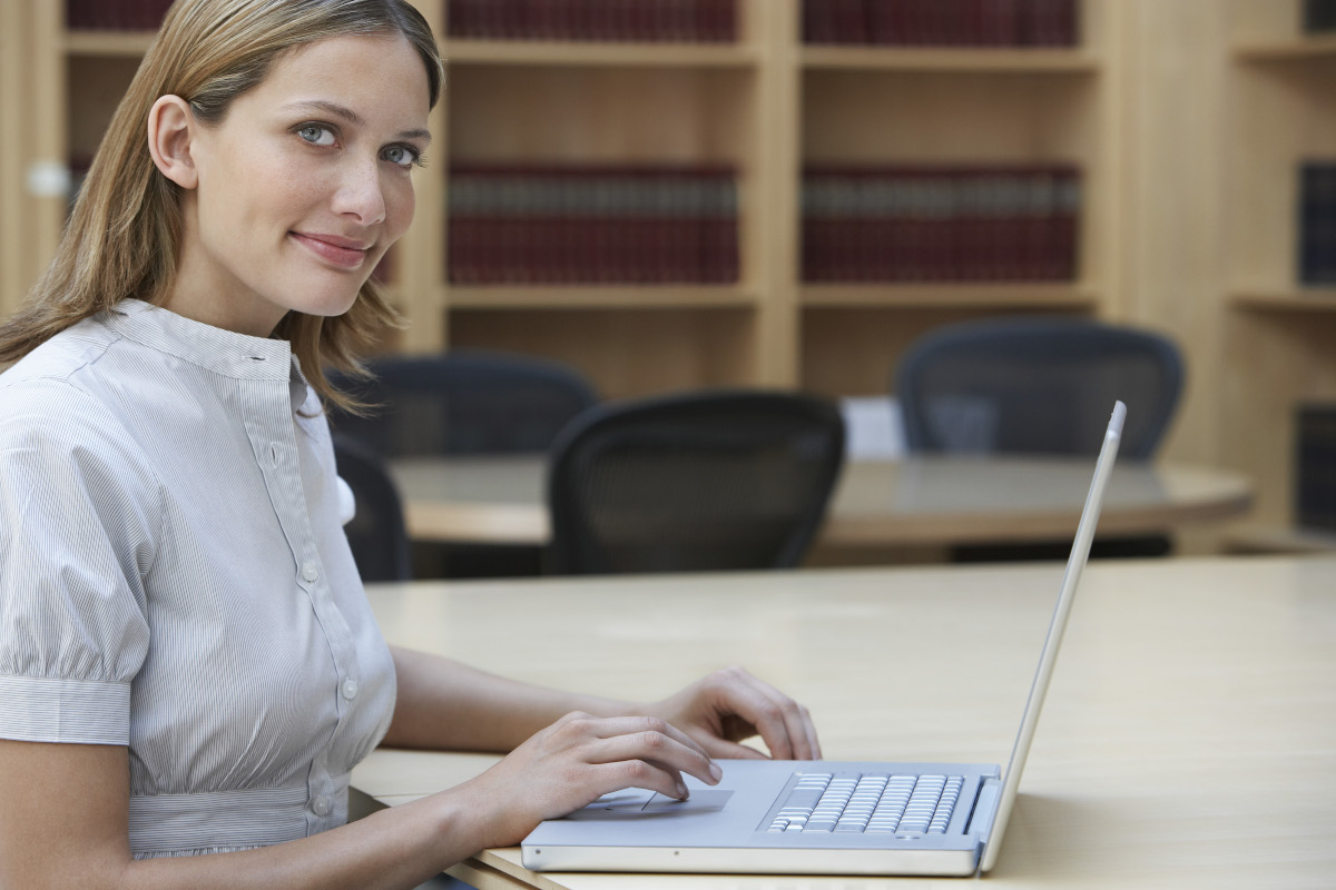 Office worker using laptop in legal office, portrait